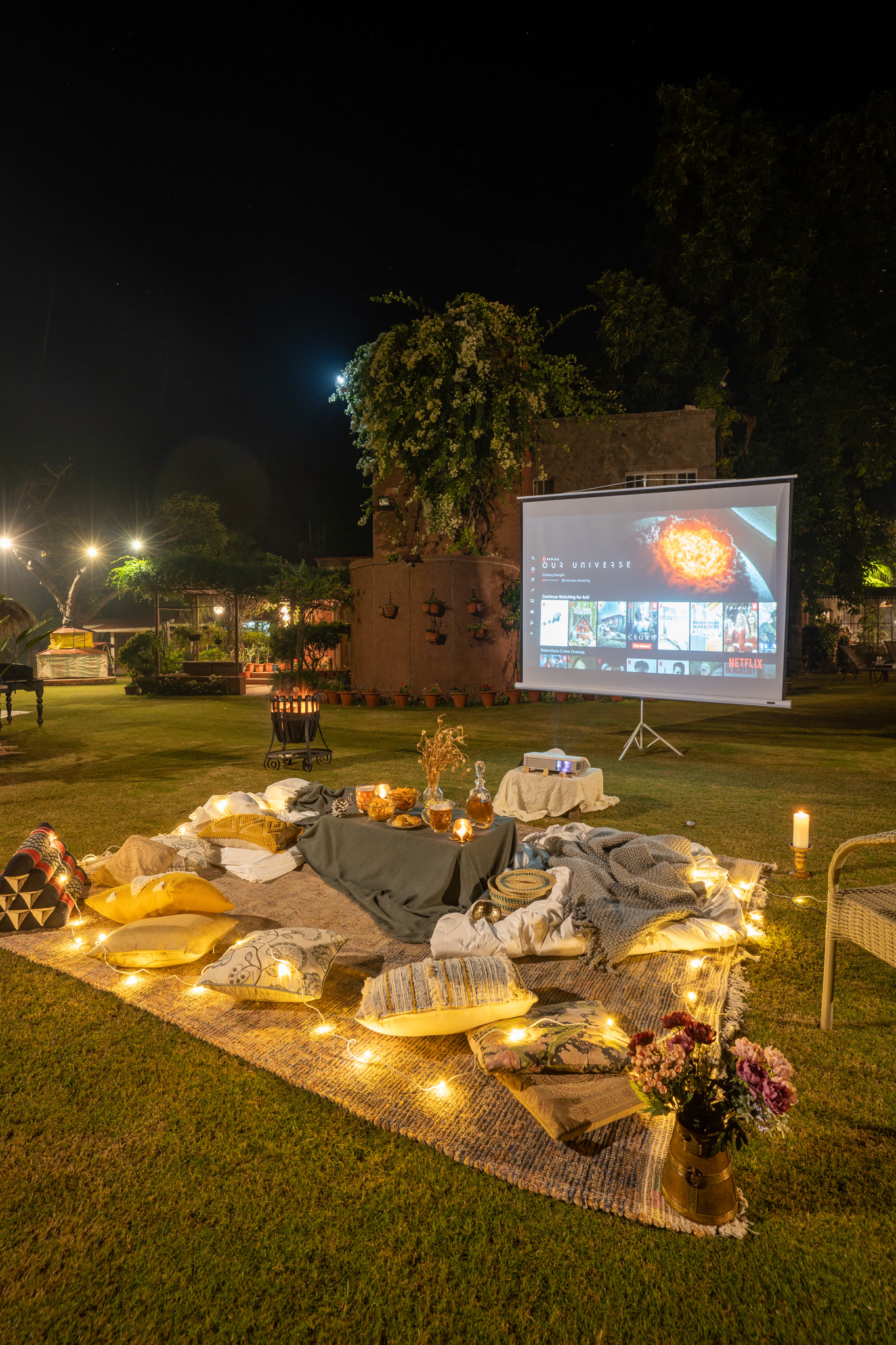 A film screen and cushions on the lawn at night