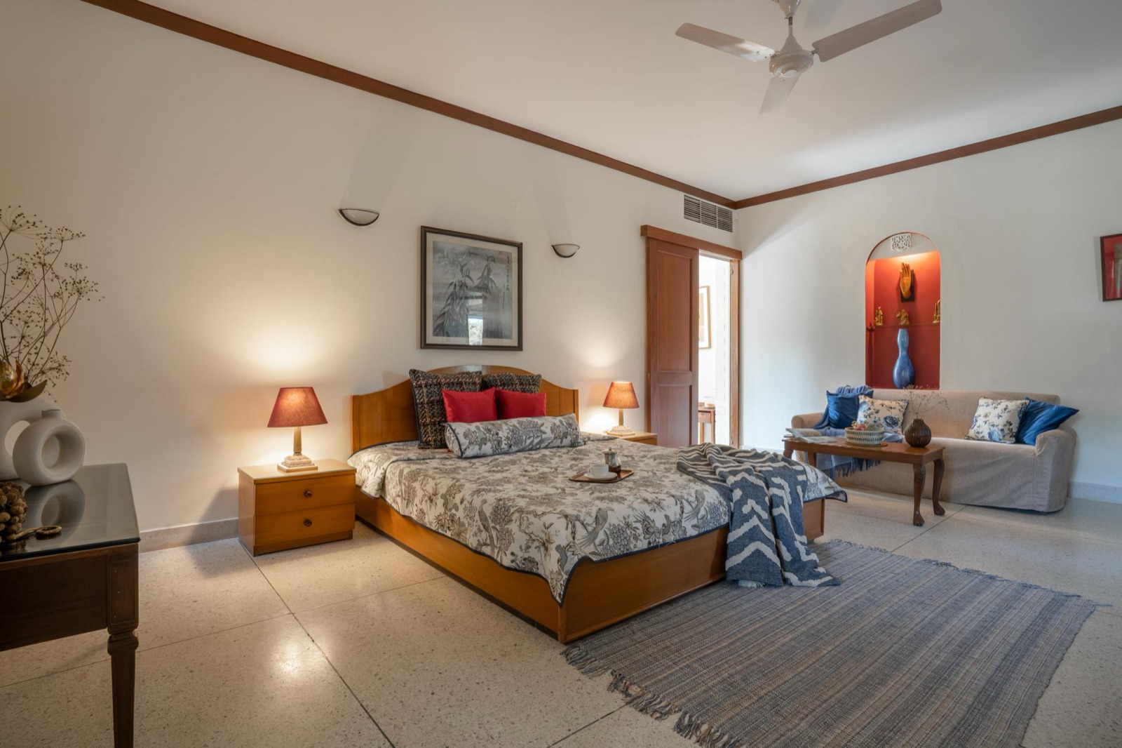 The Sambhar suite: a double bed and a sofa in one long, light room